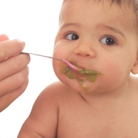 Child eating pureed peas