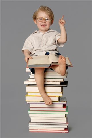 Child sitting on a pile of books