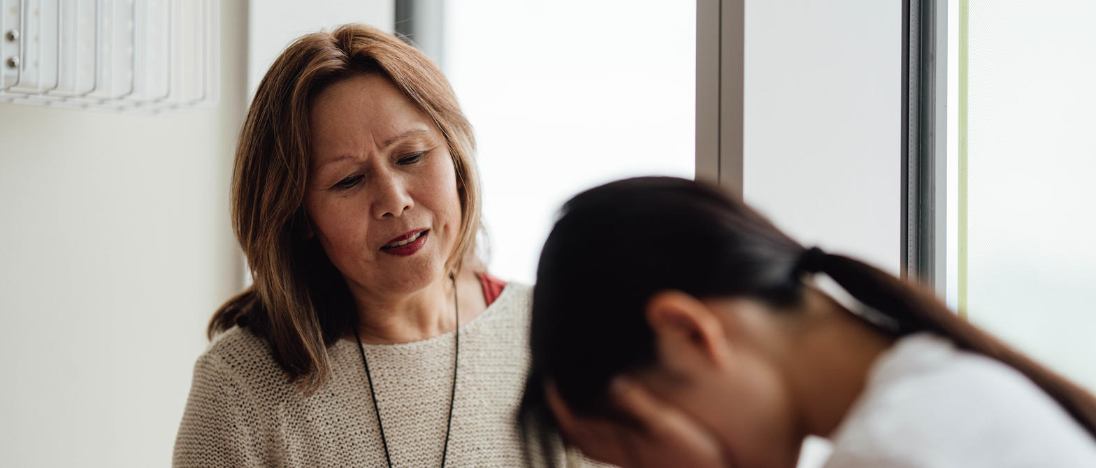 Mental Health Nurse consoling distraught child