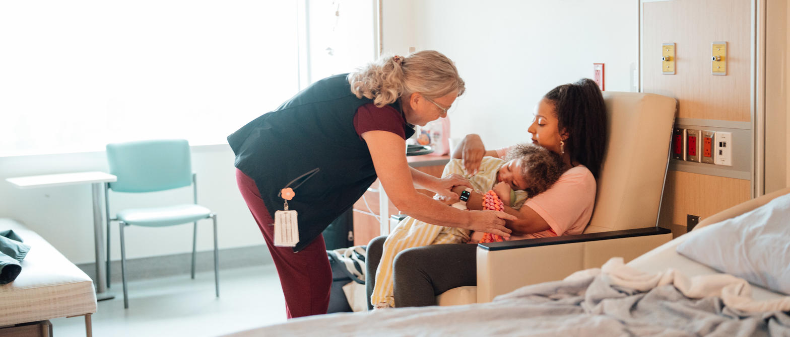 Nurse tending to child and parent