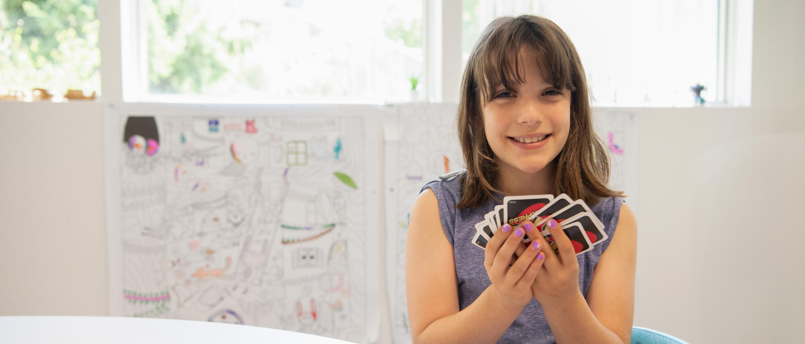 A child playing a card game in BC Children's Hospital