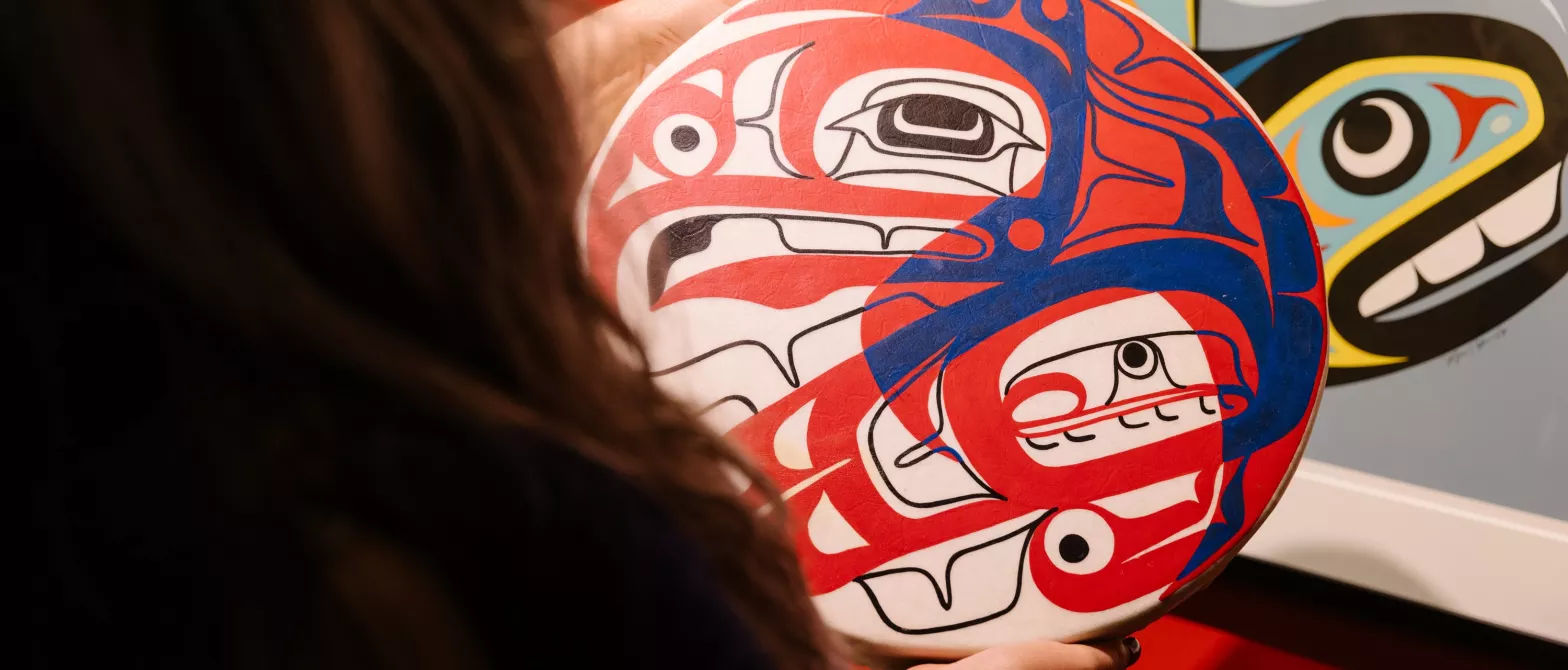 Person holding Indigenous artwork