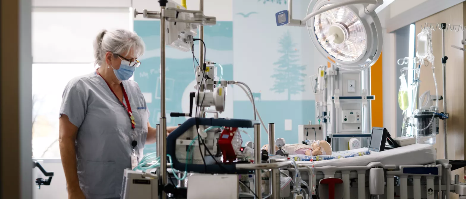 Nurse with infant practice doll