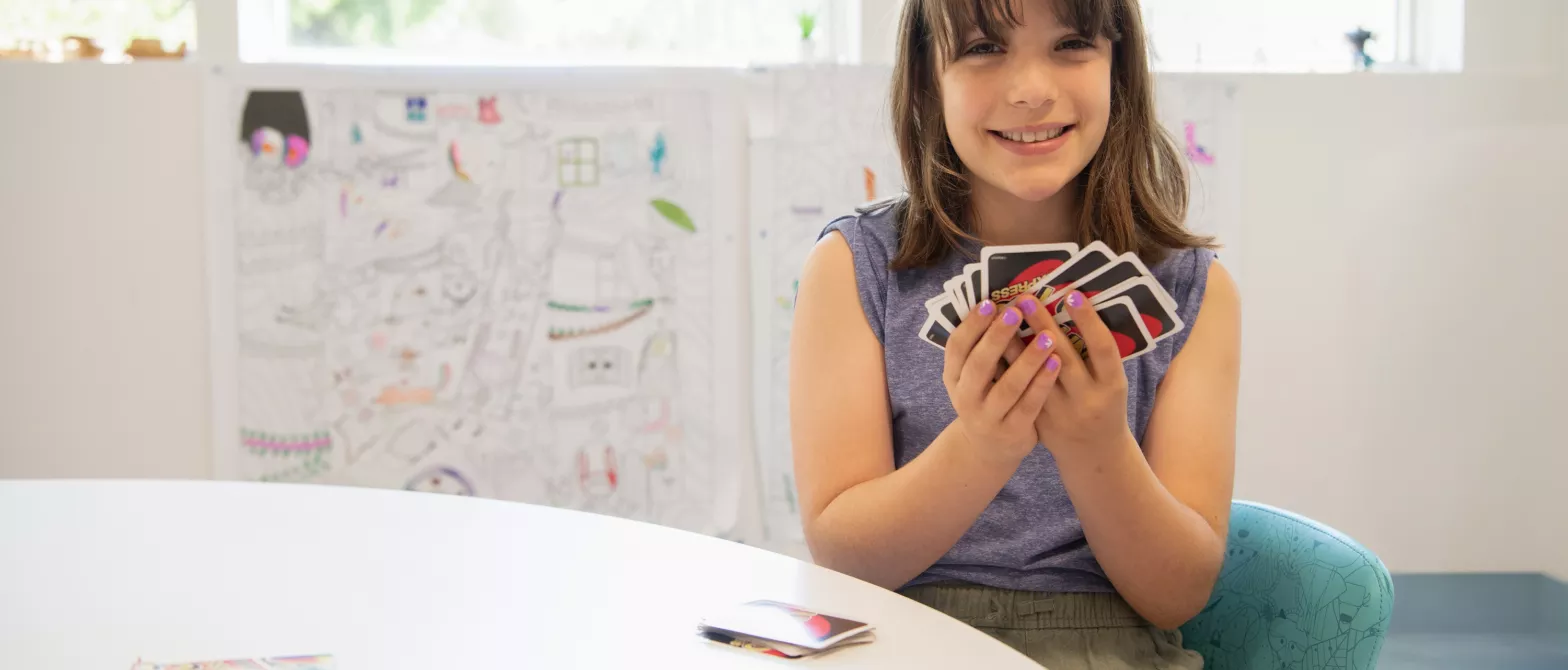 A child playing a card game in BC Children's Hospital