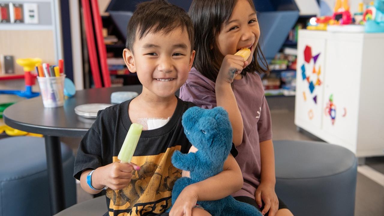 Smiling children eating popsicles