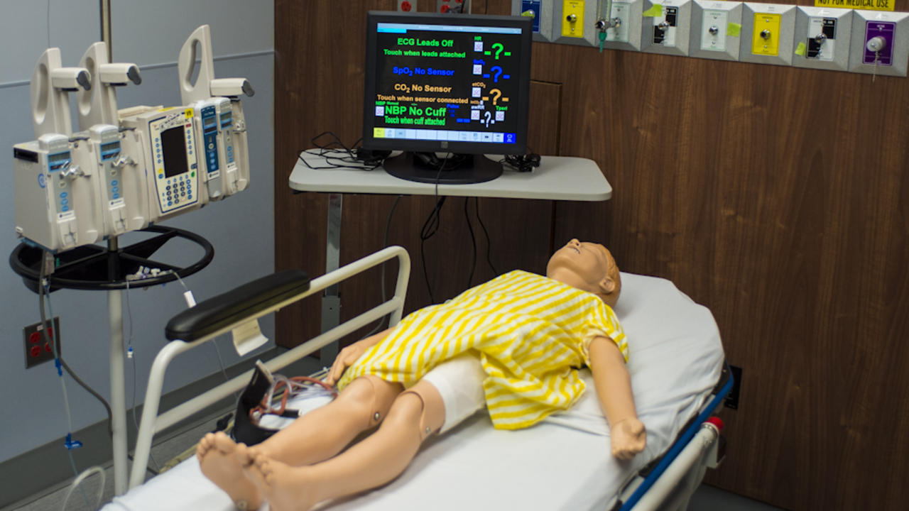 Dummy patient in simulated hospital room