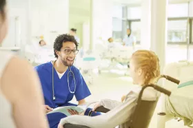 Male Emergency Dept. Nurse with kid in wheelchair