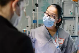 Masked staff with IV pole