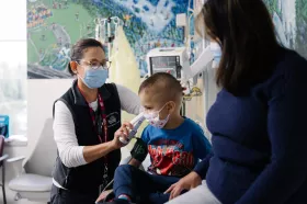 Nurse practitioner with child and parent