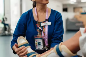 An occupational therapist helping a patient with a brace