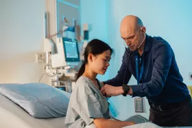 A physician working with a young patient