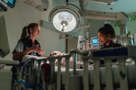 Two respiratory therapists working with a young patient