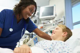 Nurse leaning over child patient