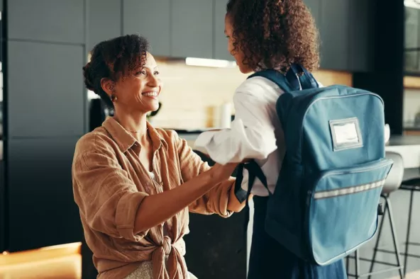 Mom, girl and happy with school uniform in home for preparing or ready for elementary education.