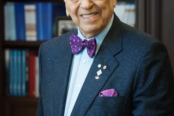 Dr. Mowafaghian posing in a library