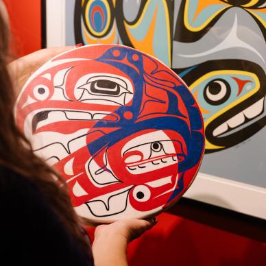 Person holding Indigenous artwork